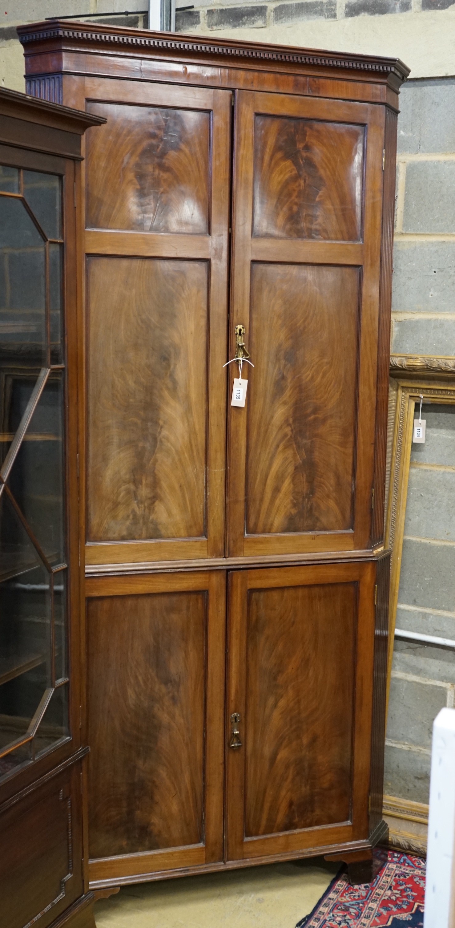 A George III mahogany standing corner cabinet, width 106cm, depth 55cm, height 228cm